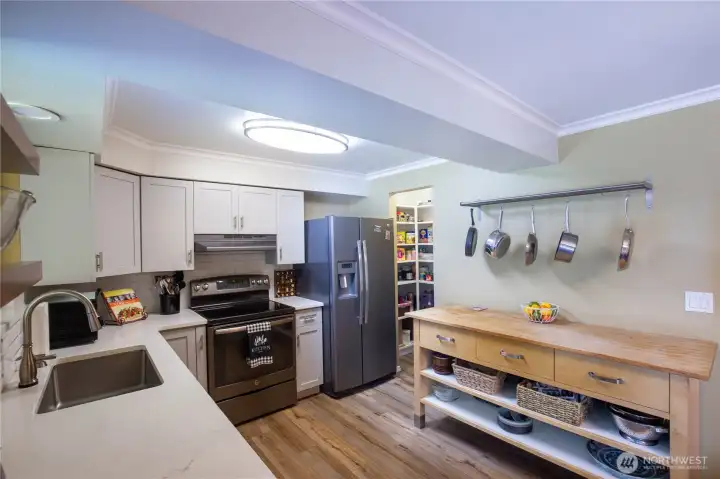 This beautiful updated kitchen is light and bright with newer cabinets, quartz countertops, and stainless appliances all stay.
