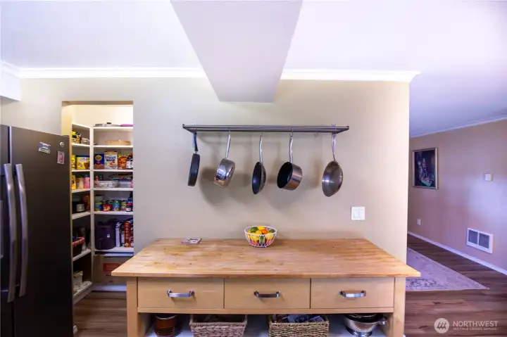 This custom wood working table provides more storage and work space, with the walk-in pantry so handy.