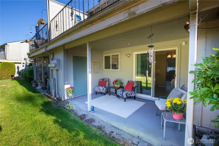 The sliders from the dining area lead to the covered patio with a storage room. Enjoy this beautiful setting for morning coffee or relaxation and destress time.