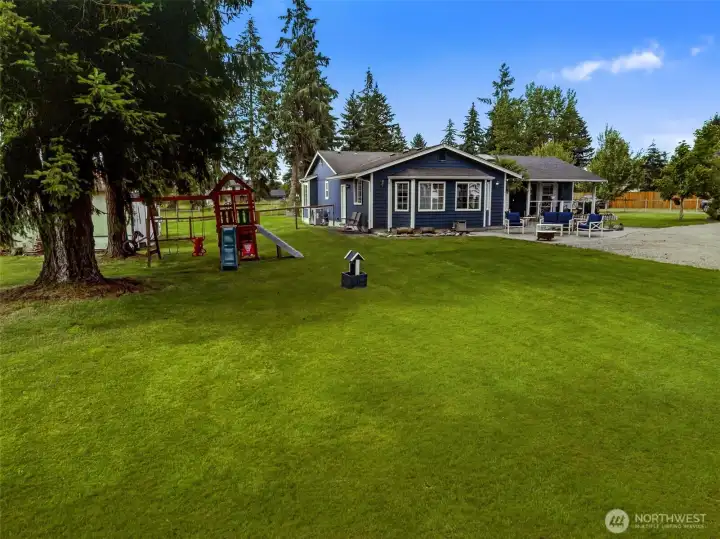 Massive park-like yard with beautiful green grass and all the fun things to do.