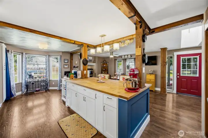Looking back towards the front door. Beautiful beams and a massive butcher block island with plentiful storage.