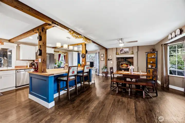 Kitchen and dining space with a cozy pellet stove. Great flow throughout the entire home.