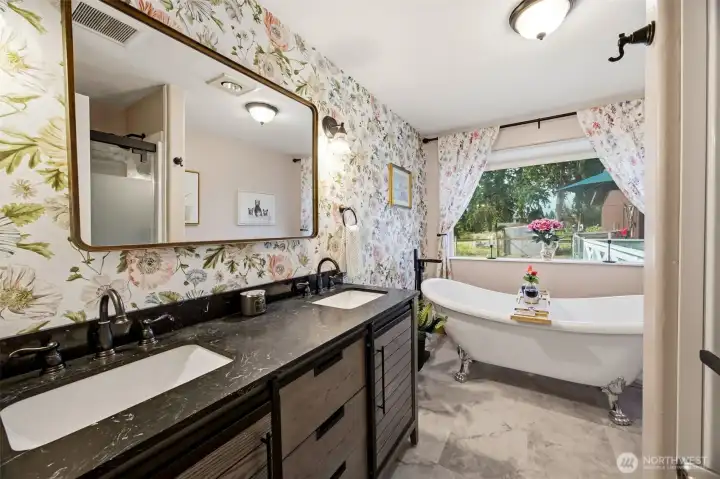 Gorgeous recently remodeled guest bathroom with a beautiful claw foot tub and nice fresh shower stall too!