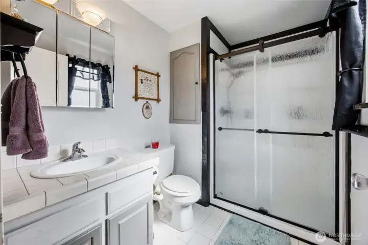Refreshed primary bathroom with good storage space!