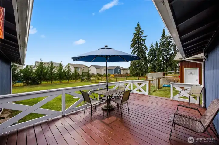 Deck off of the back of the house with entrance into the mud room. Door to the right is into the oversized shop.