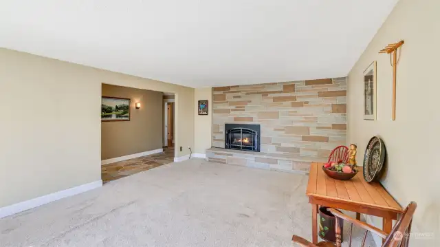 Living room with full stone wall and gas fireplace