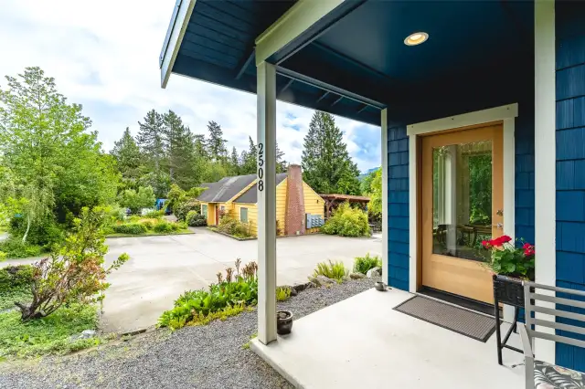 Front door with view of common house and parking