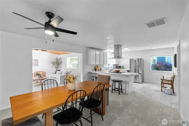 DINING ROOM | You'll love the connection between the formal dining room, the kitchen that provides 3 eating areas! Dine at the big table, the counter or the eat-in area that can fit a small table (pictured here with a bench.)