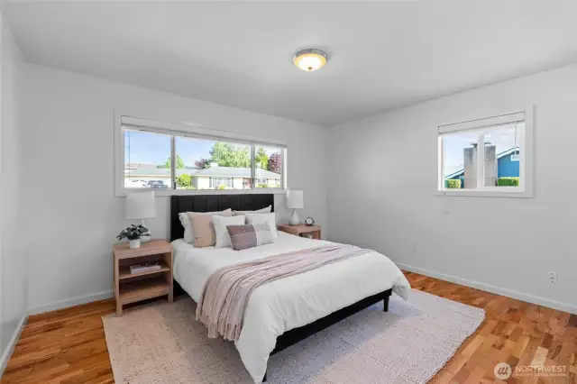 PRIMARY BEDROOM | This sweet room is located at the front of the home and features hardwood floors and fresh paint.