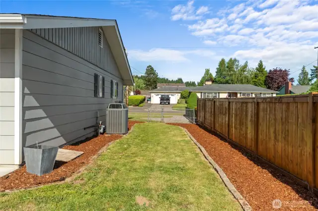 LEFT SIDE OF THE HOME | This fully-fenced lot feature a combination of wood and cyclone fencing.