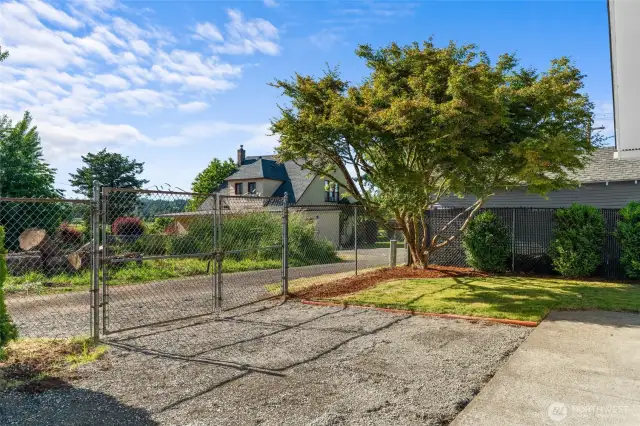 ALLEY ACCESS | This is such a great feature. With newly repaired gates that open and close smoothly, you can use this gravelled space for additional parking.