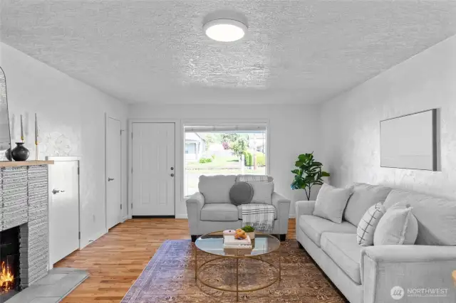 LIVING ROOM | With a coat closet and cubby for wood storage that's accessed from the garage there's a place for everything in this room. Enjoy your large picture window that allows lot of natural light and a view of your pretty neighborhood.
