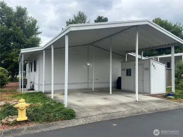 2 covered side-by-side parking spaces, and a private shed.
