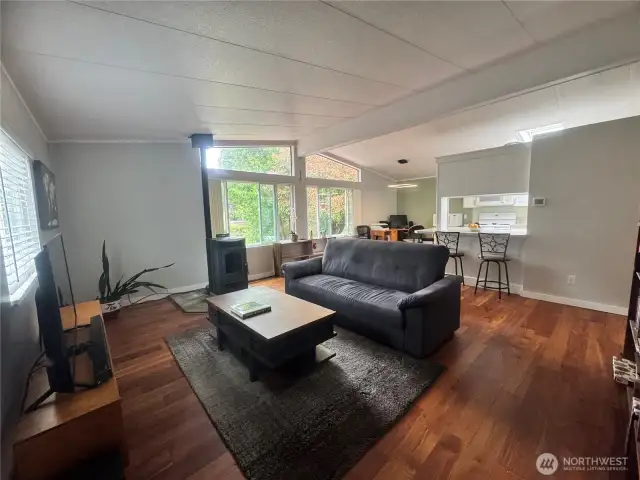 The vaulted ceiling allows extra windows to let in more of the view out to the waterfront. See the rich tones of the Luxury Vinyl Plank floor.
