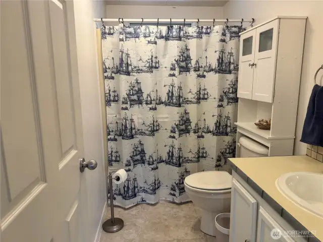 The second bathroom is roomy and light-filled. It has a soaking tub for relaxing long soaks and a shower for quick, hot showers.