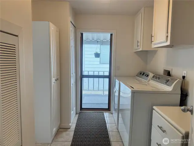 The laundry room offers even more storage cabinets and cupboards.