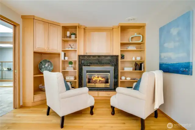 Other half of the nook off the kitchen with gas fireplace & additional custom cabinets.