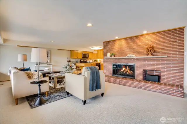 Gas fireplace on lower level with full hearth for additional seating.  Kitchen adjoins with eating bar.