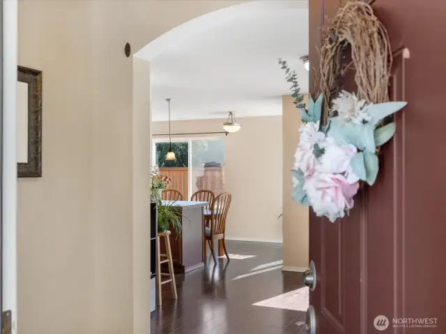 View into home from front doorstep looking through foyer to open concept living space