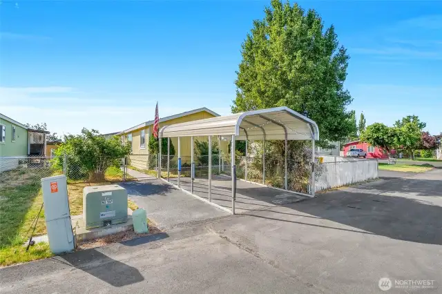This lot features a metal carport to keep your car in the shade, out of the heat and winter snow.