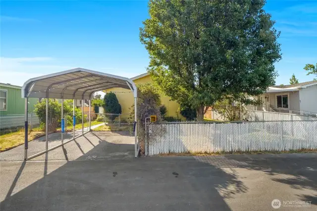 Having slats in the fence helps with privacy, and the carport will keep your car protected from the sun.