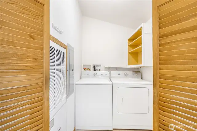 We all love it when the utility/laundry room is separate from the living space, and this one has extra room plus shelving!  Over to the right is the back door access to the secret cottage garden out back.