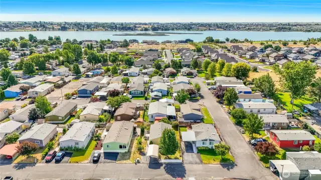 Hidden by the tree, but discovered due to the telltale carport out front, #56 is the second home from the right on the bottom in the photo.