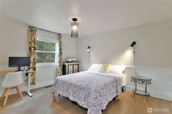 Bedroom 2 : Bright and inviting—southeast-facing bedroom with backyard views and stylish barn door closet.