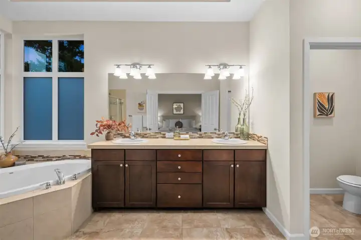 Primary suite features double sinks, large soaking tub, shower, huge walk-in closet, and separate toilet room.