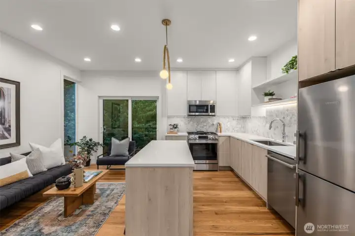 Sleek quartz countertops, premium stainless steel appliances, and a floating island made for casual mornings.