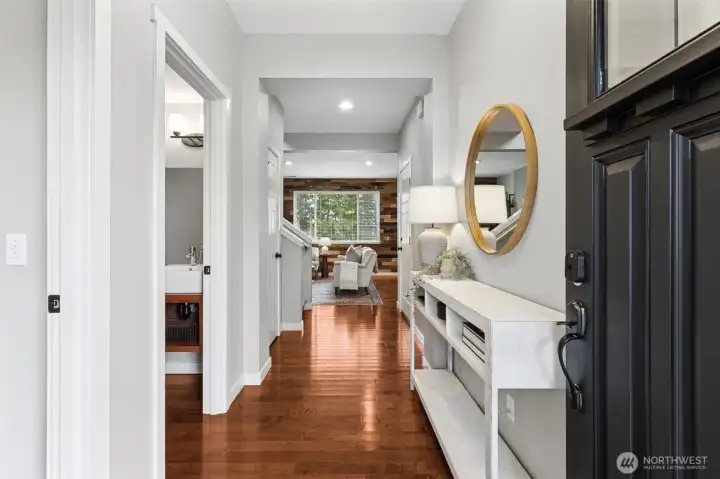 Beautiful entryway showcases gleaming hardwood floors and the territorial view from the living area.