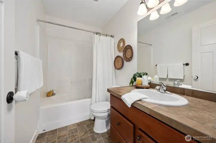 Guest full bathroom on upper level.