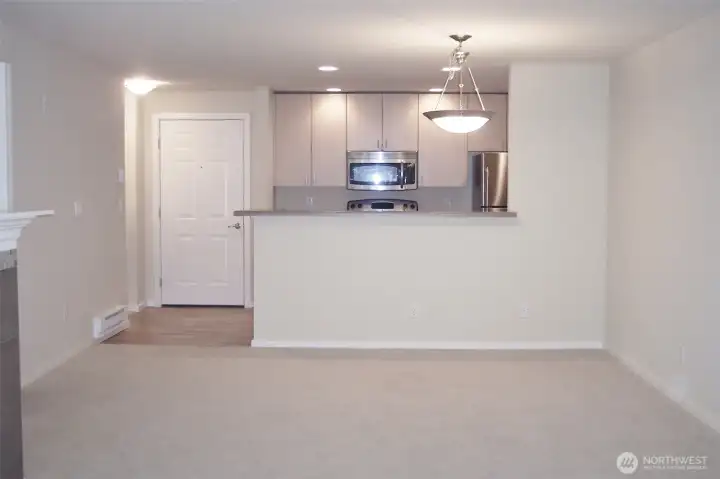 View from LR to Kitchen/Dining shown vacant