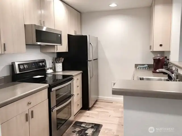 Kitchen is open to greatrooom which allows good natural light excellent entertaining space and views to the back deck