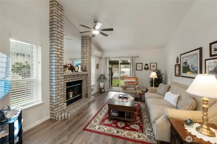 Family Room with Fireplace and slider to back Deck and Fenced Backyard