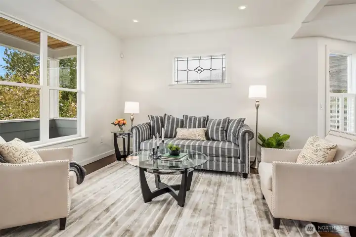 Step inside this renovated 1907 Craftsman to discover original fir hardwood floors, tall ceilings, large bay windows, and an inviting open living/dining room layout ideal for both everyday living and entertaining.