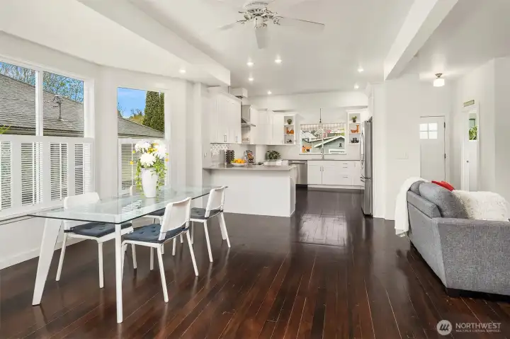 The thoughtfully updated, grand Chef's kitchen boasts sleek Quartz countertops, quality appliances include a newer fridge, induction stovetop, dishwasher, and ample cabinetry, and quiet-close, dovetailed wood drawers.