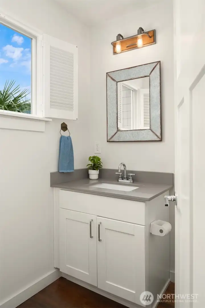 Main floor powder room carrying the finishes of Quartz countertop vanity.