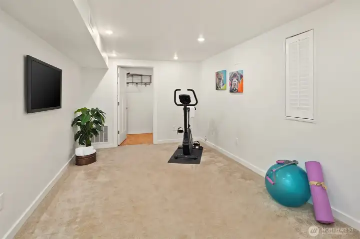 The daylight basement features tall ceilings, media room & two guest bedrooms framing a full bath.