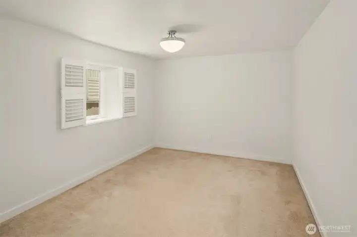 The daylight basement features tall ceilings, media room & two guest bedrooms framing a full bath.