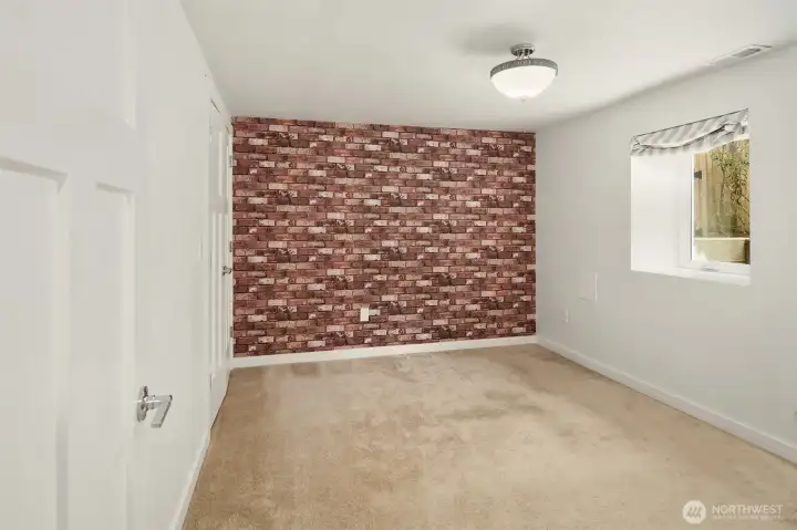 The daylight basement features tall ceilings, media room & two guest bedrooms framing a full bath.