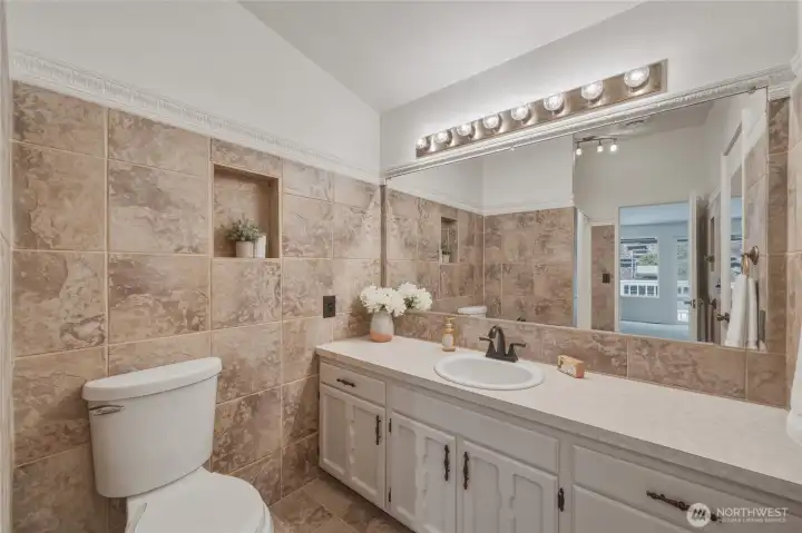 This full bathroom also has freshly painted cabinets.