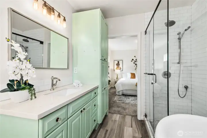 Absolutely beautiful primary bath with marble tiled shower and plenty of cabinet space.
