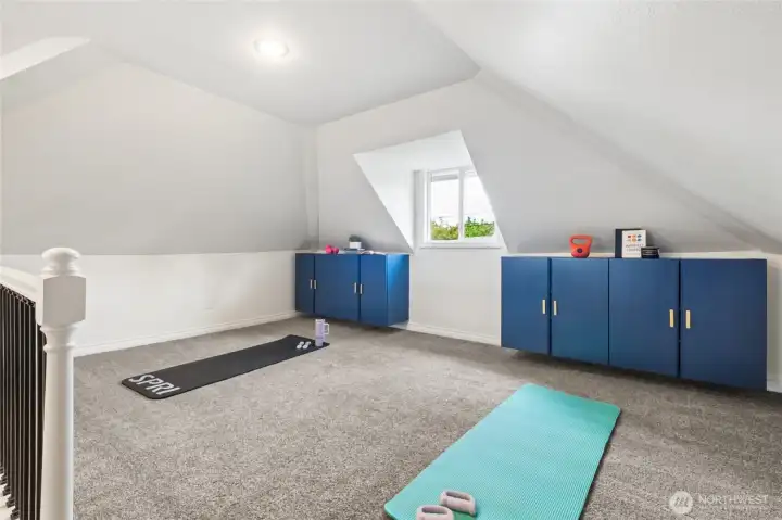Flexible upstairs attic space suitable for a variety of uses: toy storage, play space, workout, TV?