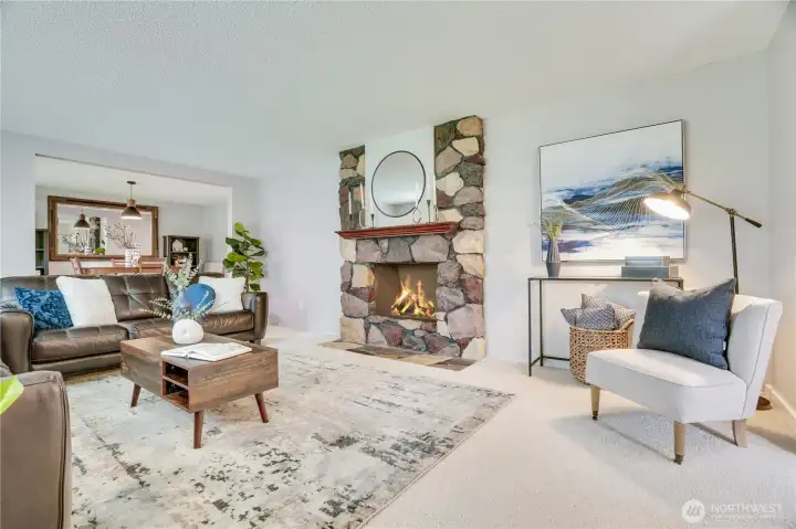 Enter to original flagstone entry and stone fireplace which warms up this living room that flows into the formal dining area.