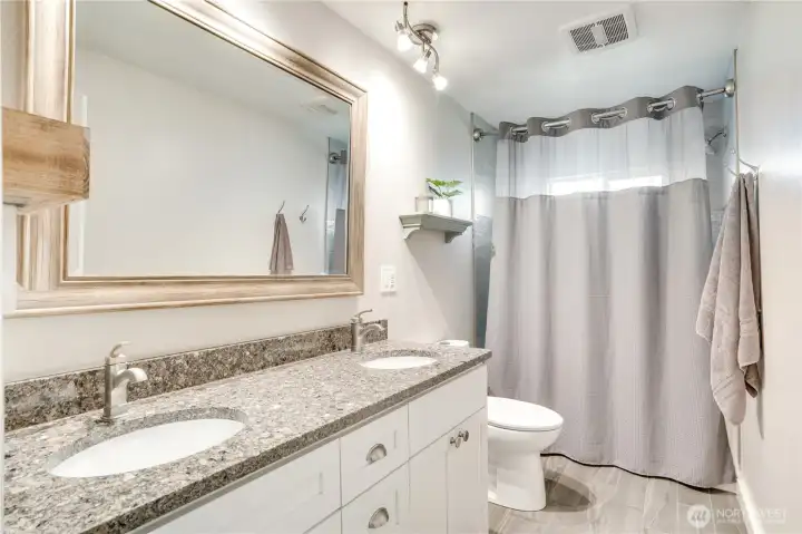 This refreshed hall bath has a timeless palette to service the additional bedrooms and your guests.
