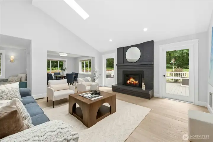 Cozy great room that serves as a livingroom with skylights and gas fireplace