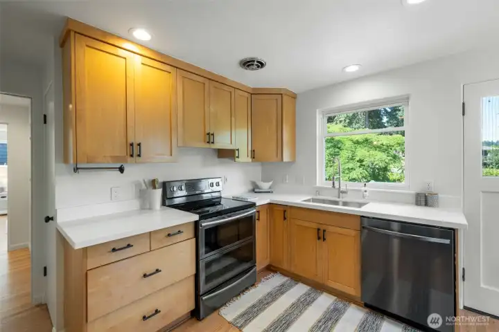 Refreshed kitchen with new countertops, sink and backsplash. Refreshed kitchen with new countertops, sink and backsplash.