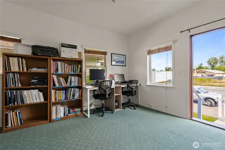 Bright front office with large windows, natural light, and direct street-level access.