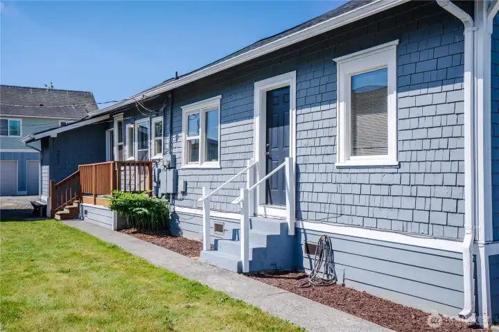 Side elevation highlighting separate entrances for office and residential/living spaces.